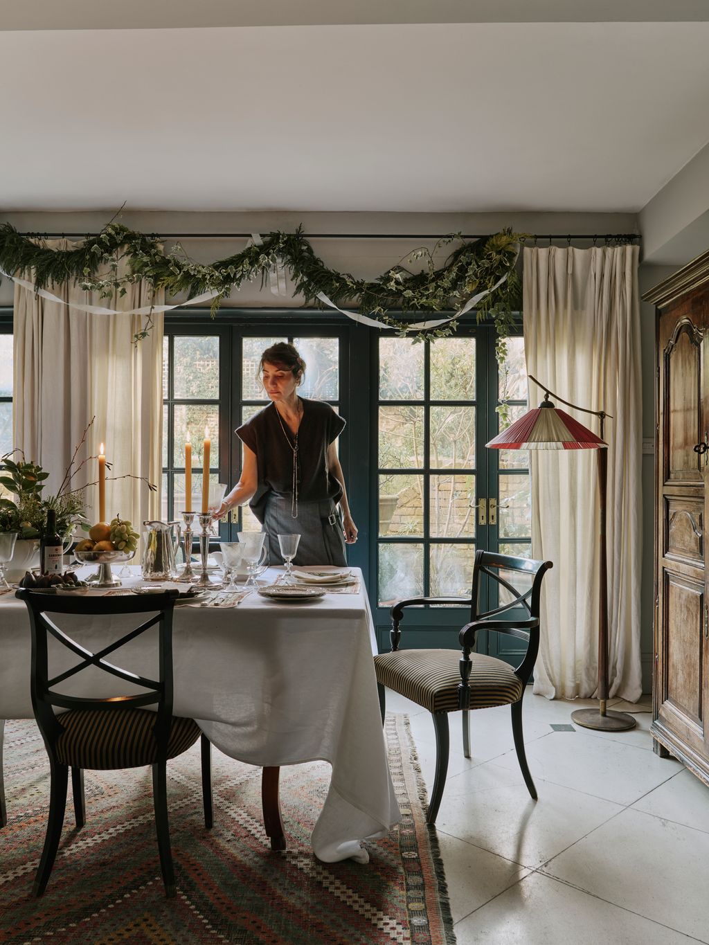 Image may contain Adult Person Furniture Table Chair Home Decor Rug Dining Table Architecture and Building